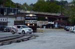 The Depot Grille's van crosses in front of NS E19.  Not to worry.  the E19 is stationary as his conductor walks the train prior to departure